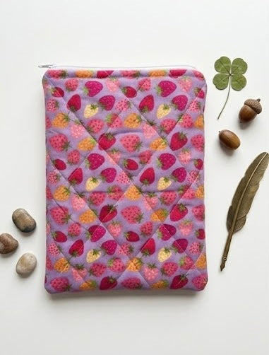 Purple book pouch with strawberry pattern on a white background
