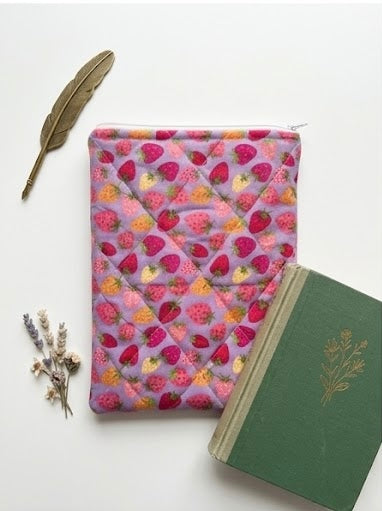 Purple book pouch with strawberry pattern on a white background