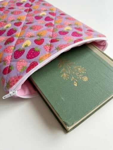 Purple book pouch with strawberry pattern on a white background